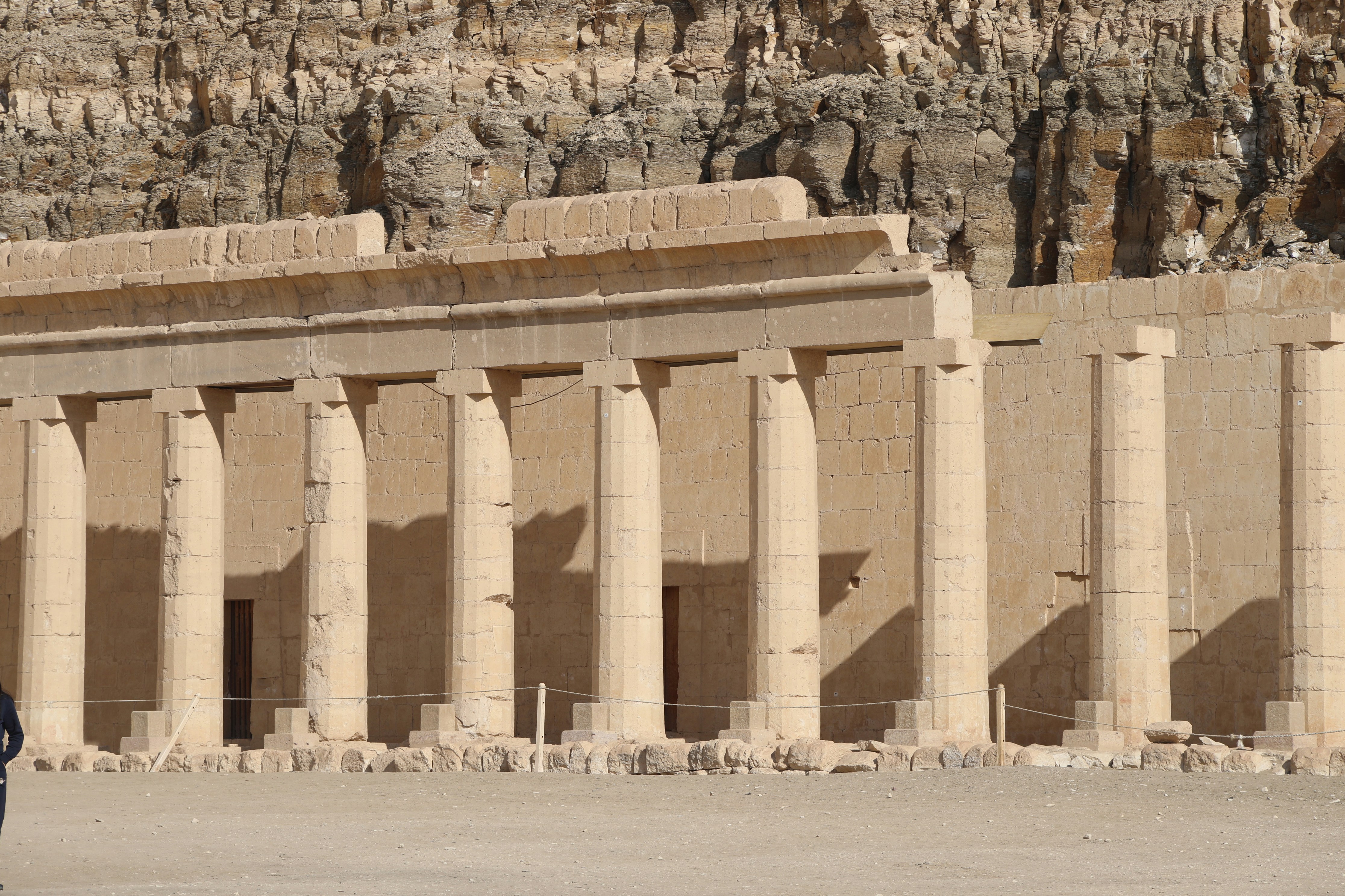 a man standing in front of a large building