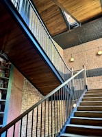 An industrial-style metal staircase with wooden steps in a loft apartment.