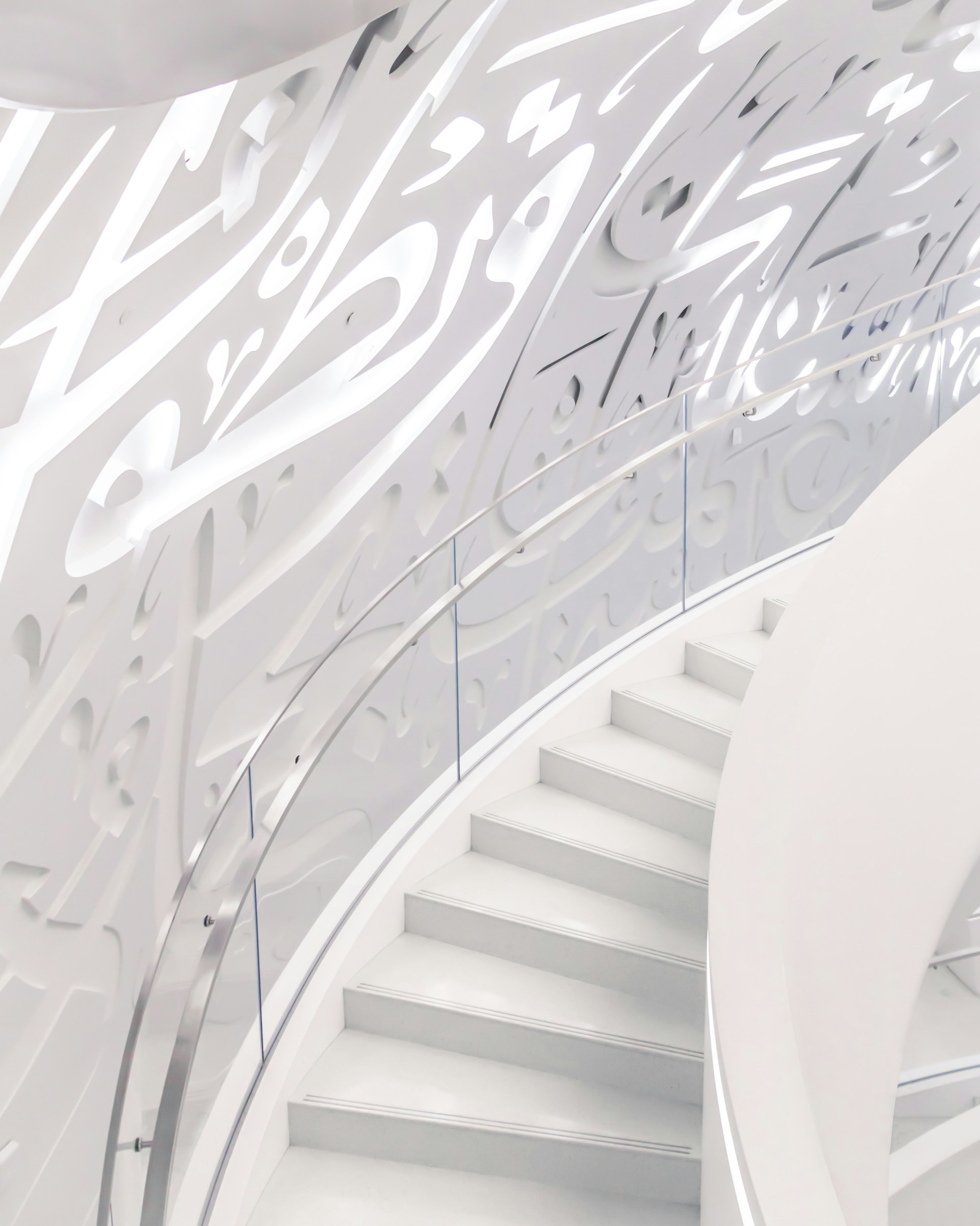 a spiral staircase in a building with white walls