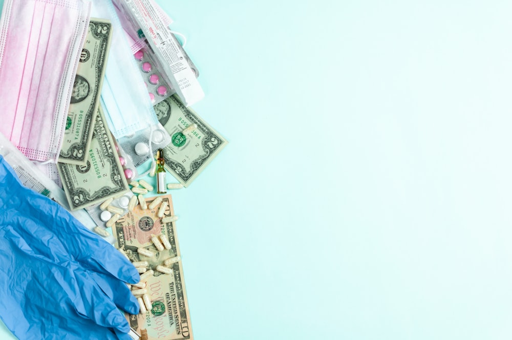 a medical mask, medical supplies, and money on a blue background