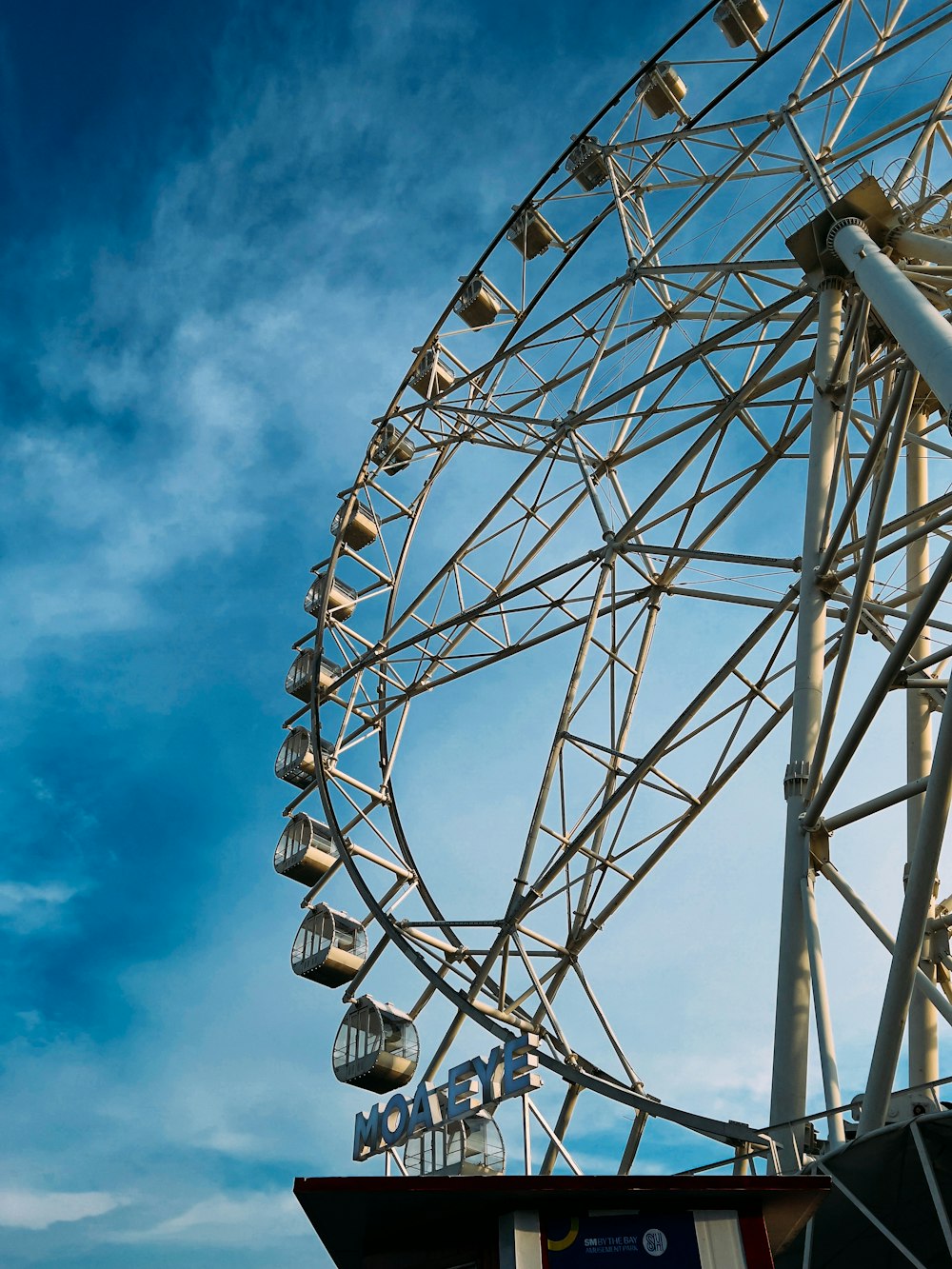 a large ferris wheel sitting under a blue sky