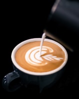Close-up of latte art being crafted with care at a coffee catering event in Klang Valley.