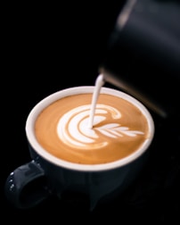 Close-up of latte art being crafted during a popup event.