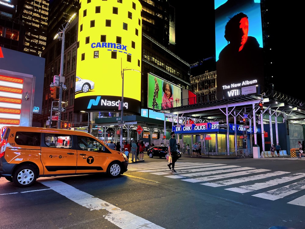 a city street at night with cars and people