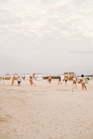 Group of young players enjoying a sunny football match on the Costa del Sol beach.