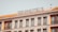 A multi-story building with a sign reading 'STARHOTELS' on the rooftop. The facade features a series of evenly spaced windows with decorative railings. The building exhibits a modern architectural design with clean lines and a neutral color palette.