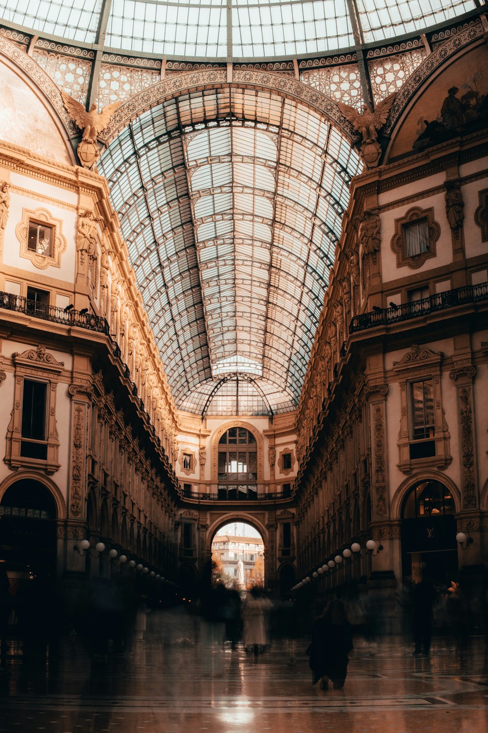 a large building with a glass ceiling and people walking around