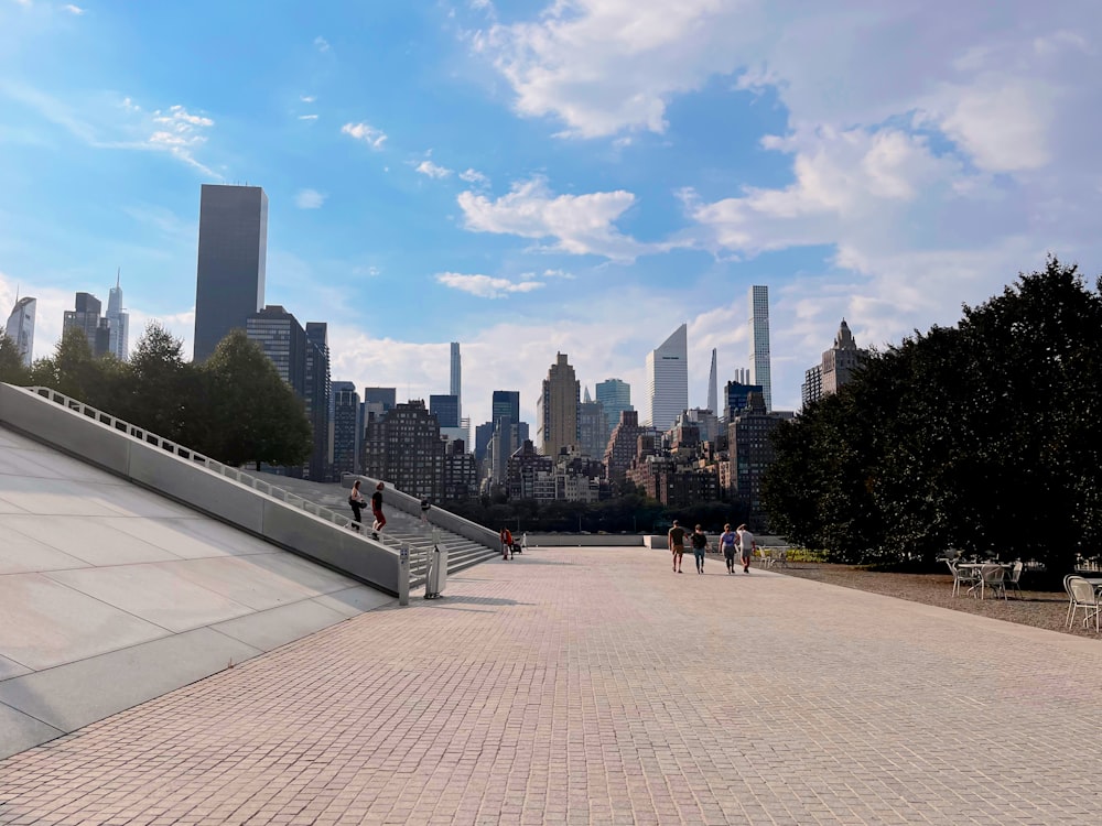 a group of people walking down a brick walkway