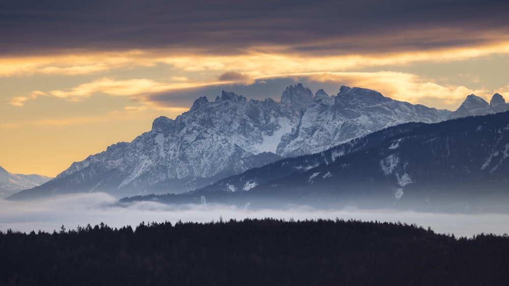 a view of a mountain range covered in clouds