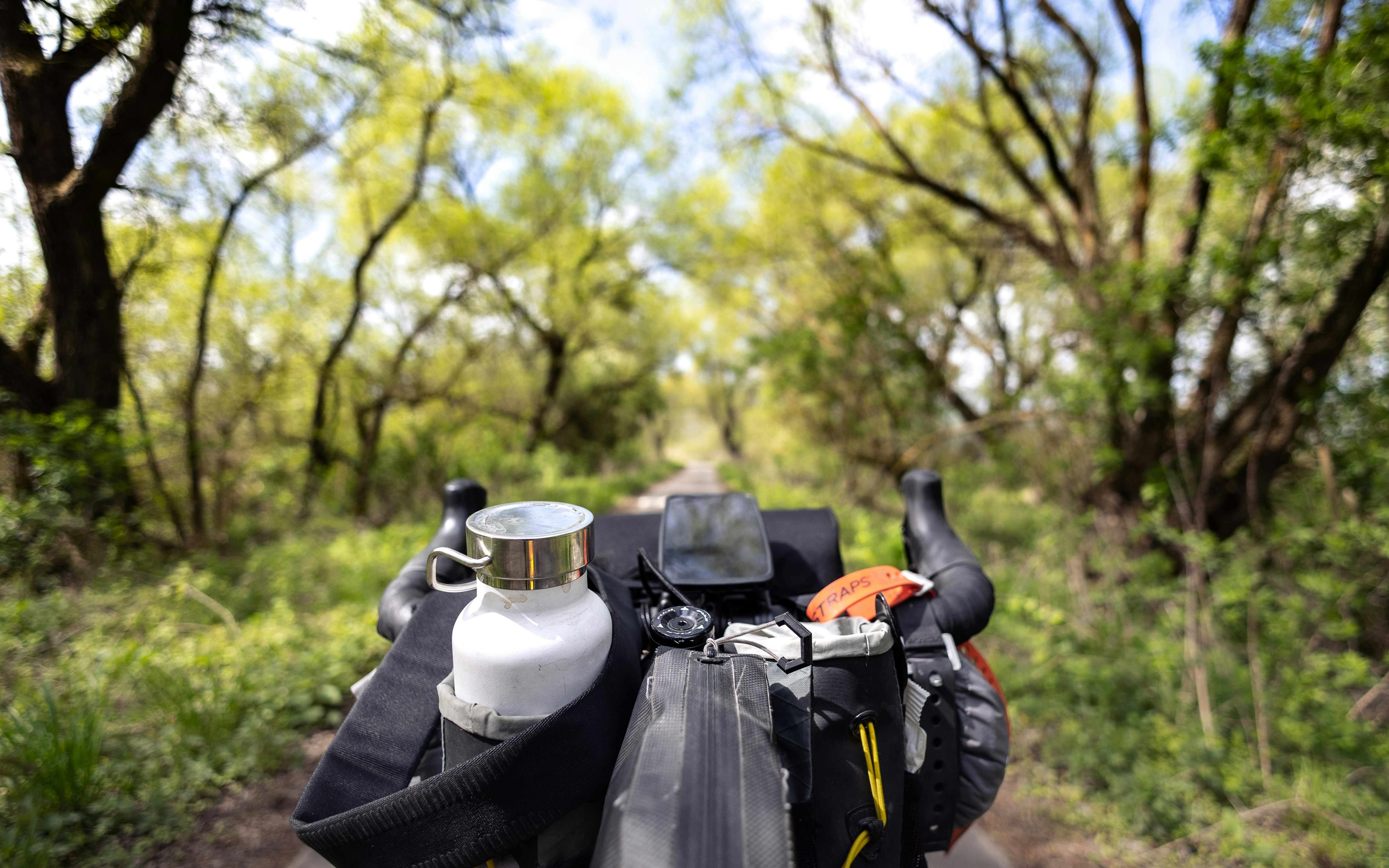 a motorcycle parked on the side of a dirt road