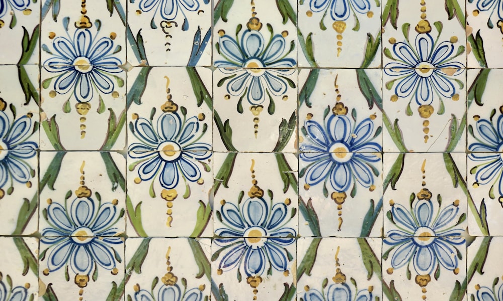 a close up of a tile with blue flowers on it