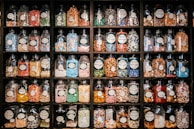 A vintage candy store shelf filled with jars of colorful sweets.
