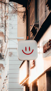 Traditional illuminated advertising sign glowing warmly on a city street at dusk