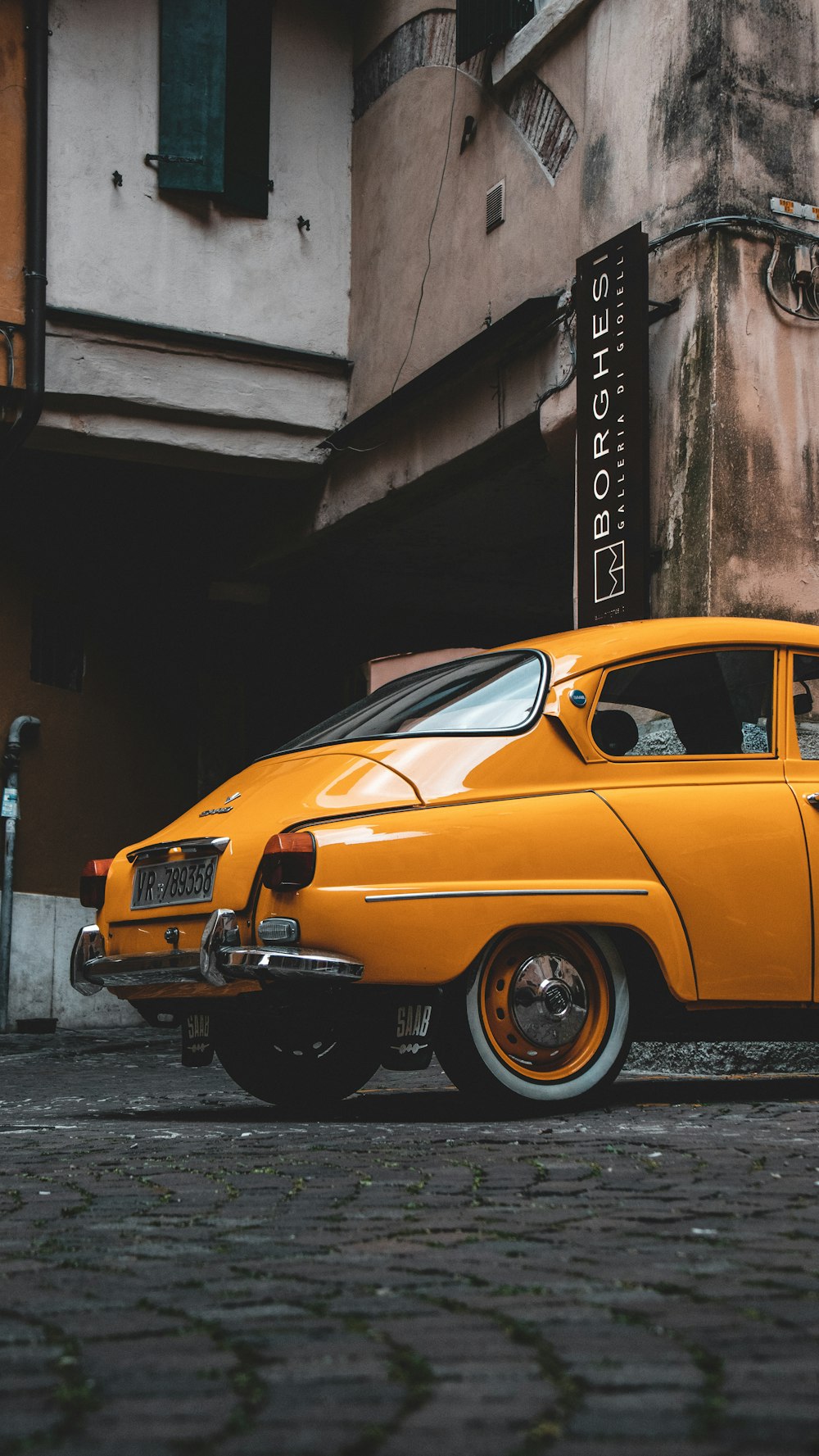 a yellow car parked on the side of the road