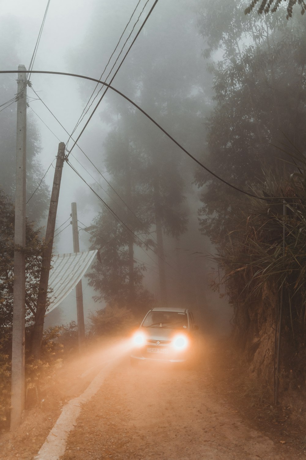 a car driving down a road in the fog