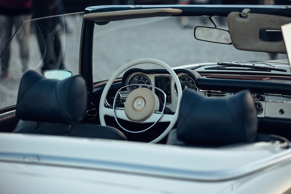 the interior of a car with a steering wheel and dashboard