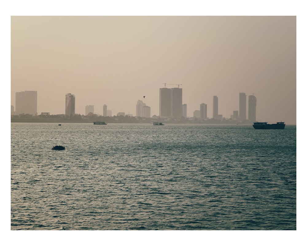 a large body of water with a city in the background