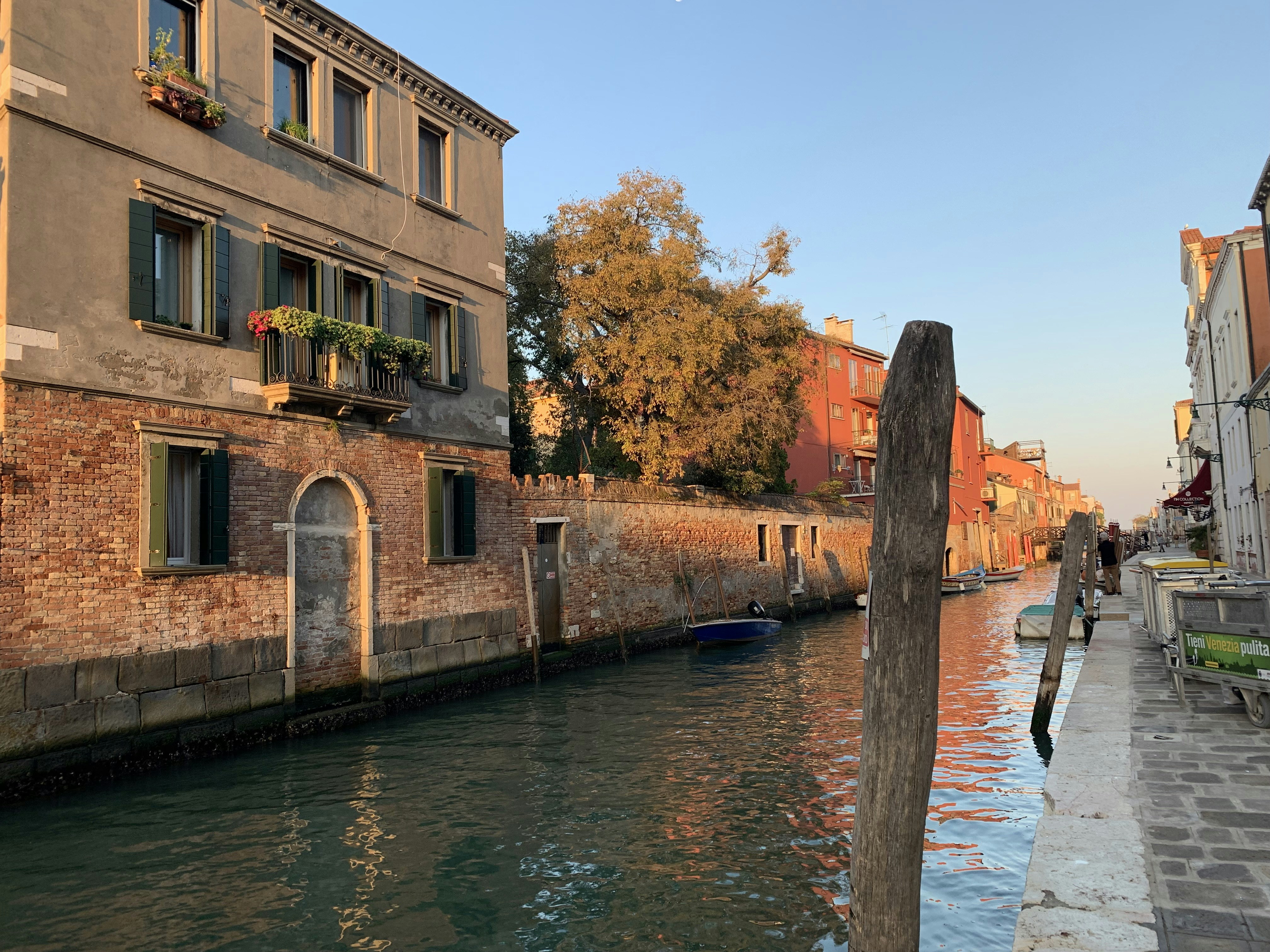 a boat is parked on the side of a canal