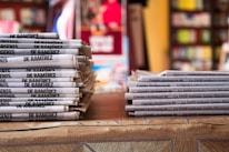 a stack of newspapers sitting on top of a table