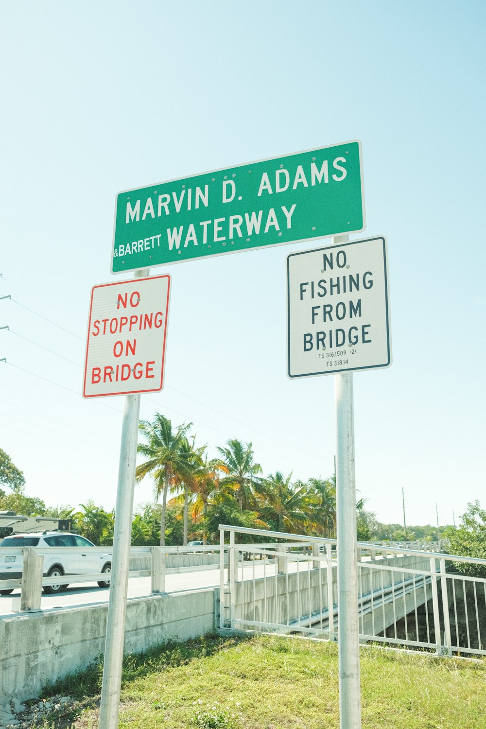 a couple of street signs sitting on the side of a road