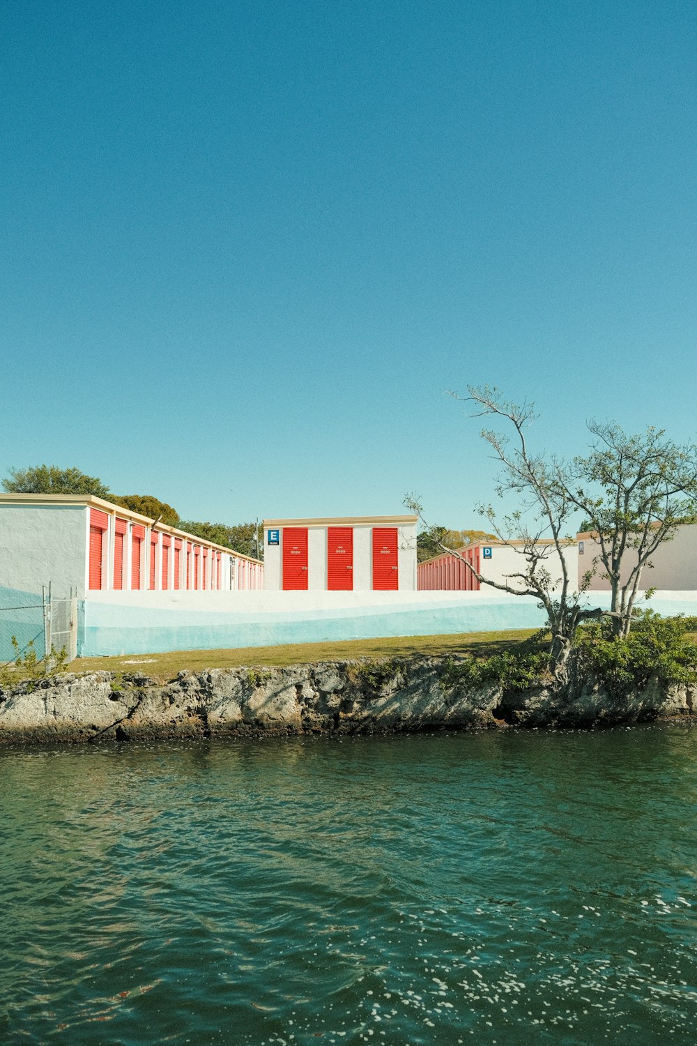 a red and white building sitting on top of a body of water