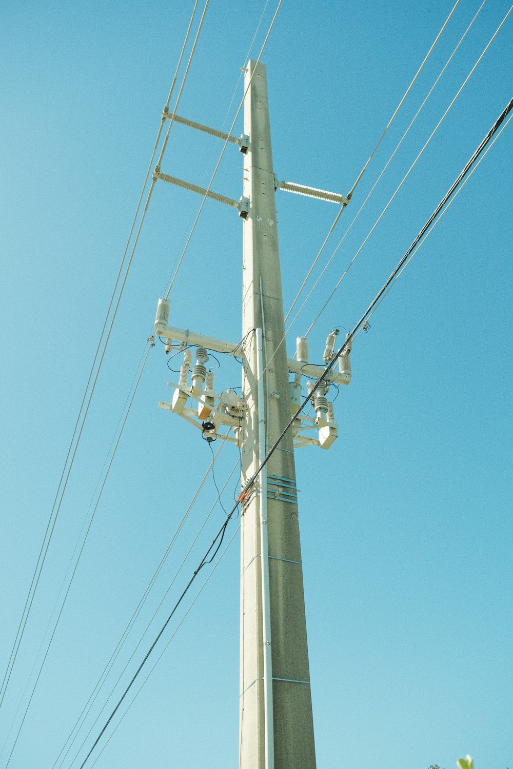 a telephone pole with a bunch of wires attached to it