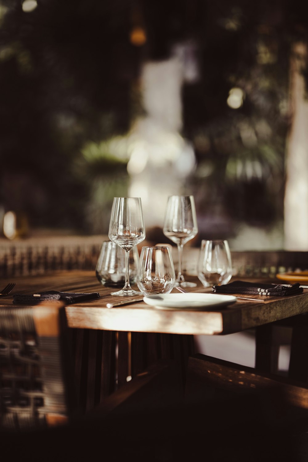 a group of wine glasses sitting on top of a wooden table