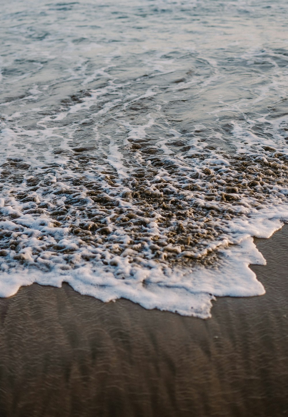 a close up of a wave on a beach