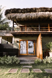 a house with a thatched roof and wooden doors