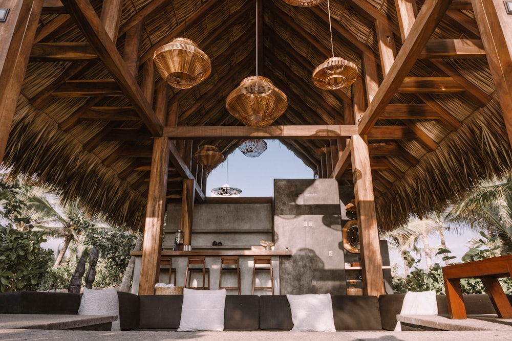 a wooden structure with hanging lights inside of it