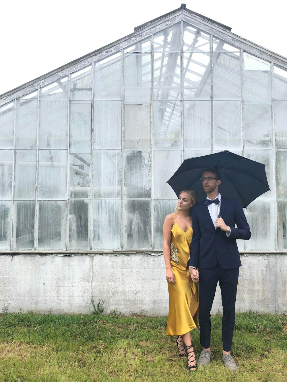 a man and a woman standing under an umbrella