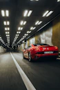 A Lamborghini captured mid-drift with sparks flying off the rear wheels in an underground tunnel.