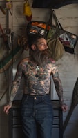 a man with a long beard and tattoos