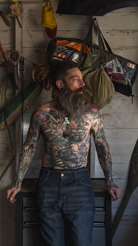 a man with a long beard and tattoos