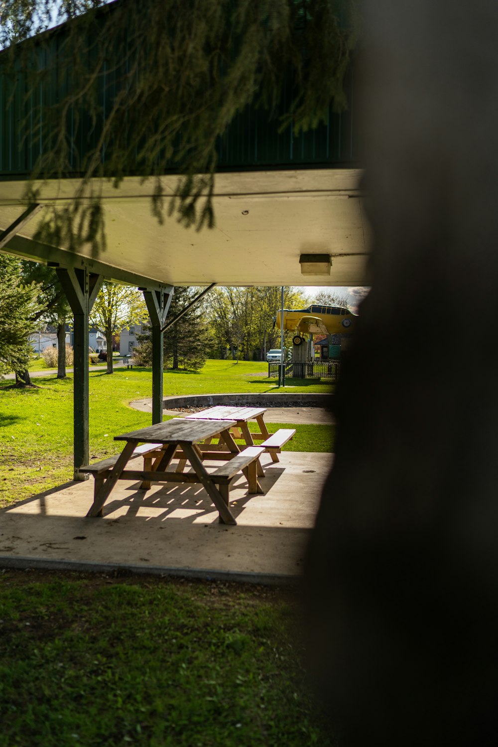 a picnic table under a covered area in a park