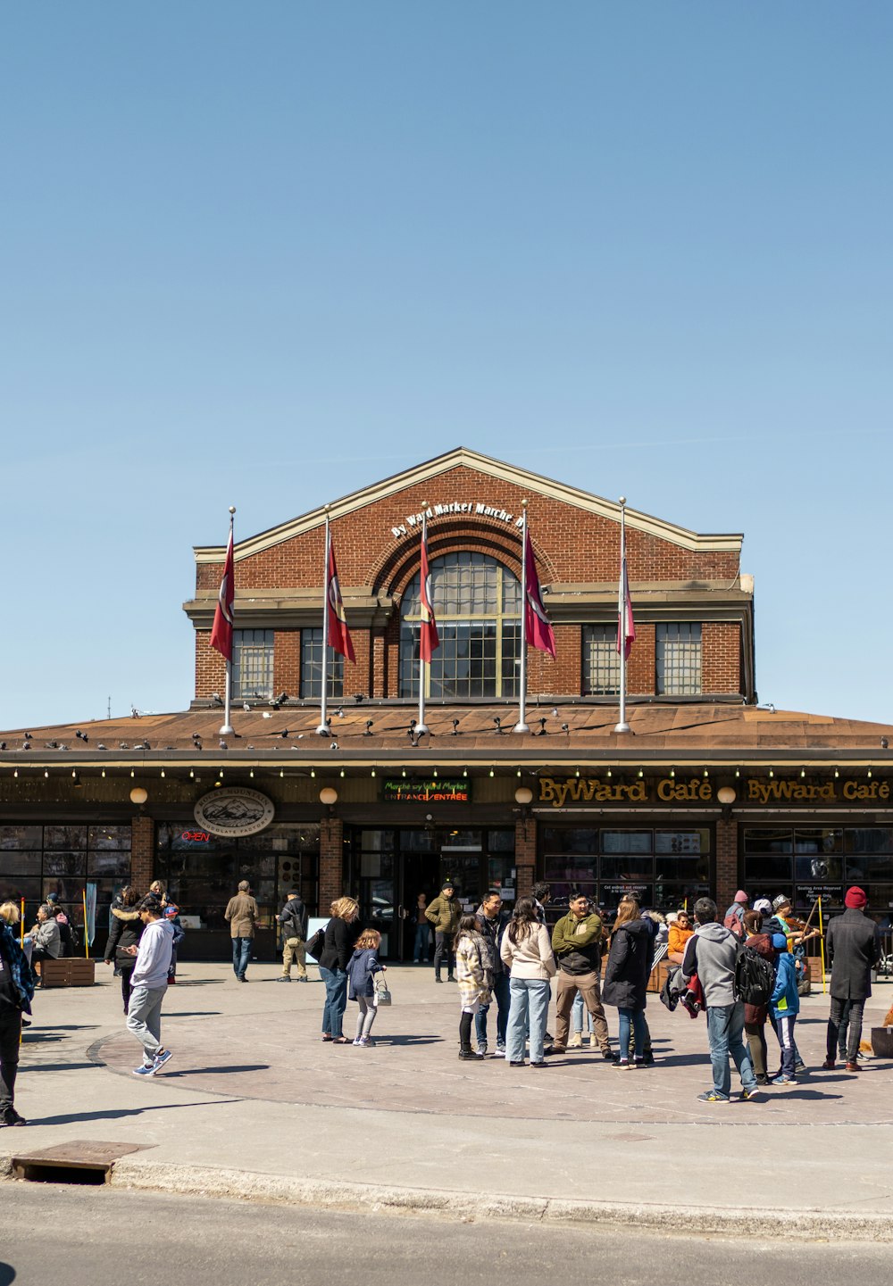 a group of people standing outside of a train station