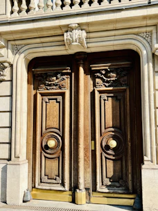Close-up of villa’s ornate wooden doors and stone facade.
