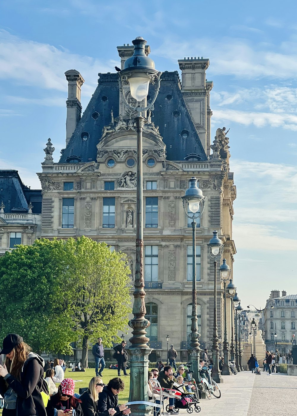 a group of people sitting on benches in front of a building