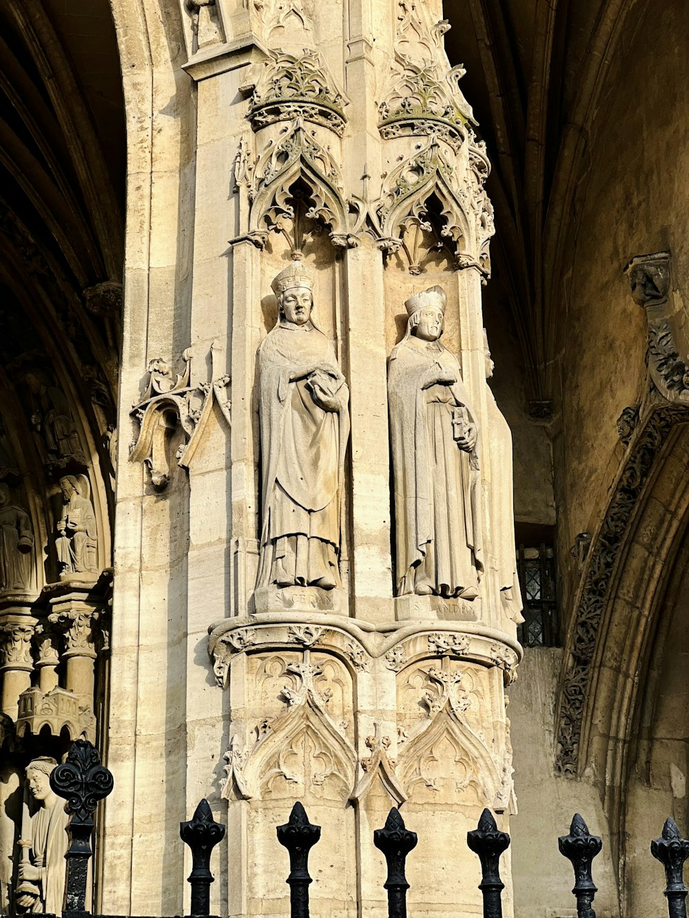 a tall building with statues on the side of it