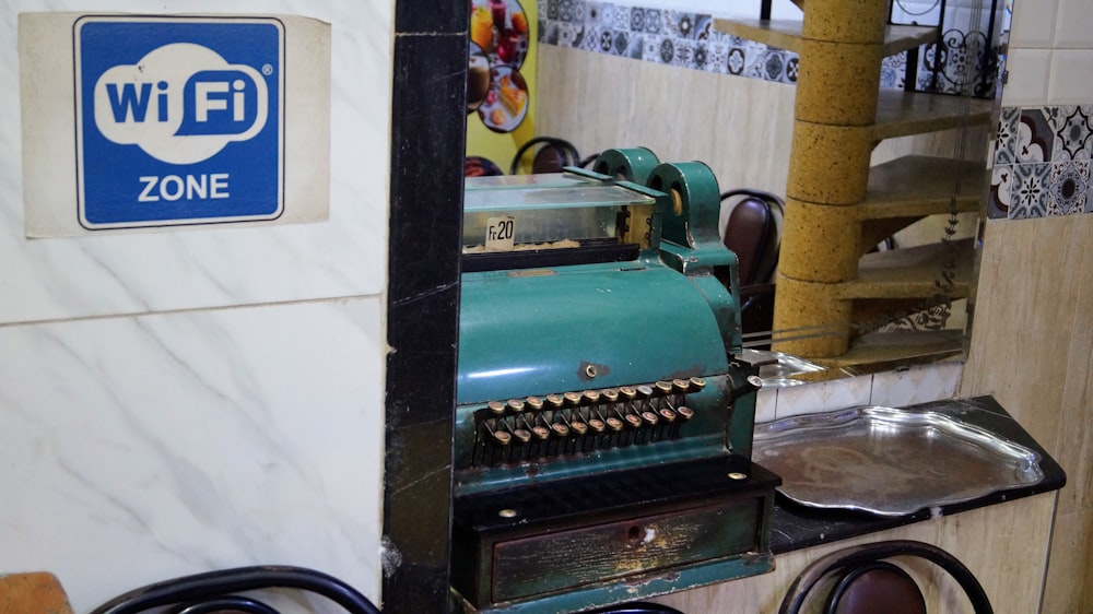 a green machine sitting on top of a counter