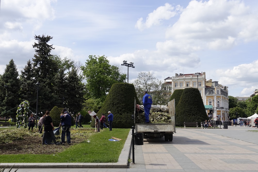 a group of people standing around in a park