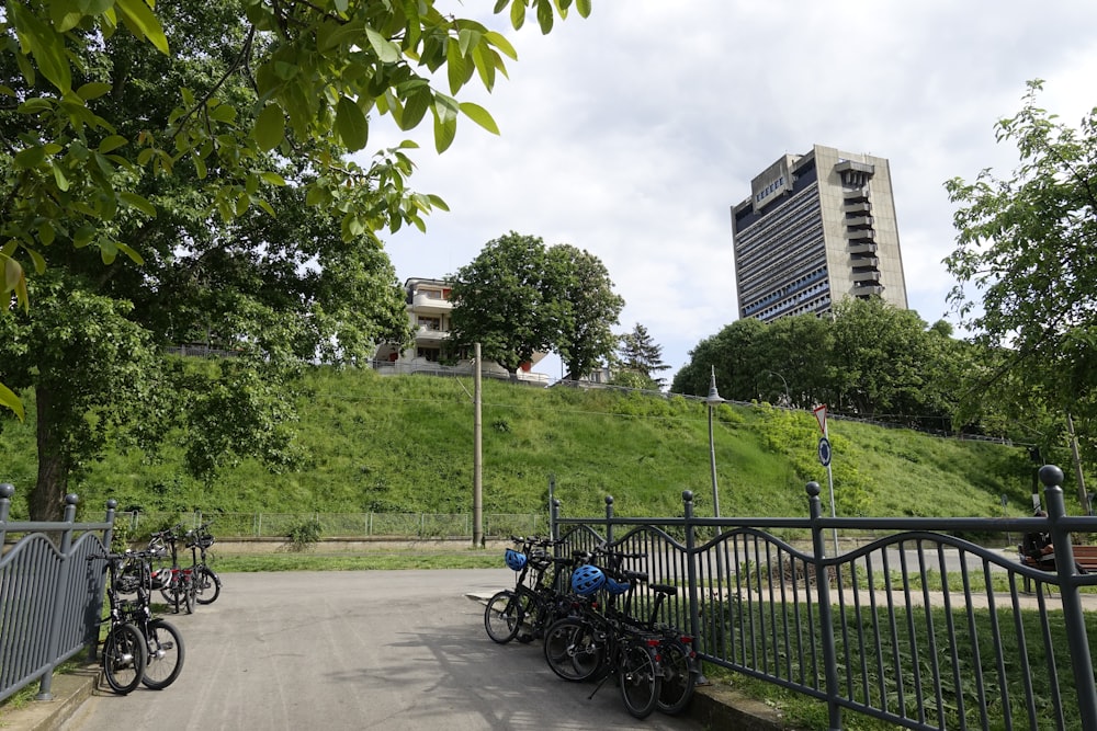 a group of bikes parked next to a metal fence