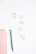Crystal-accented white coat hanging with a sleek study planner and gold pen on a minimalist white background.