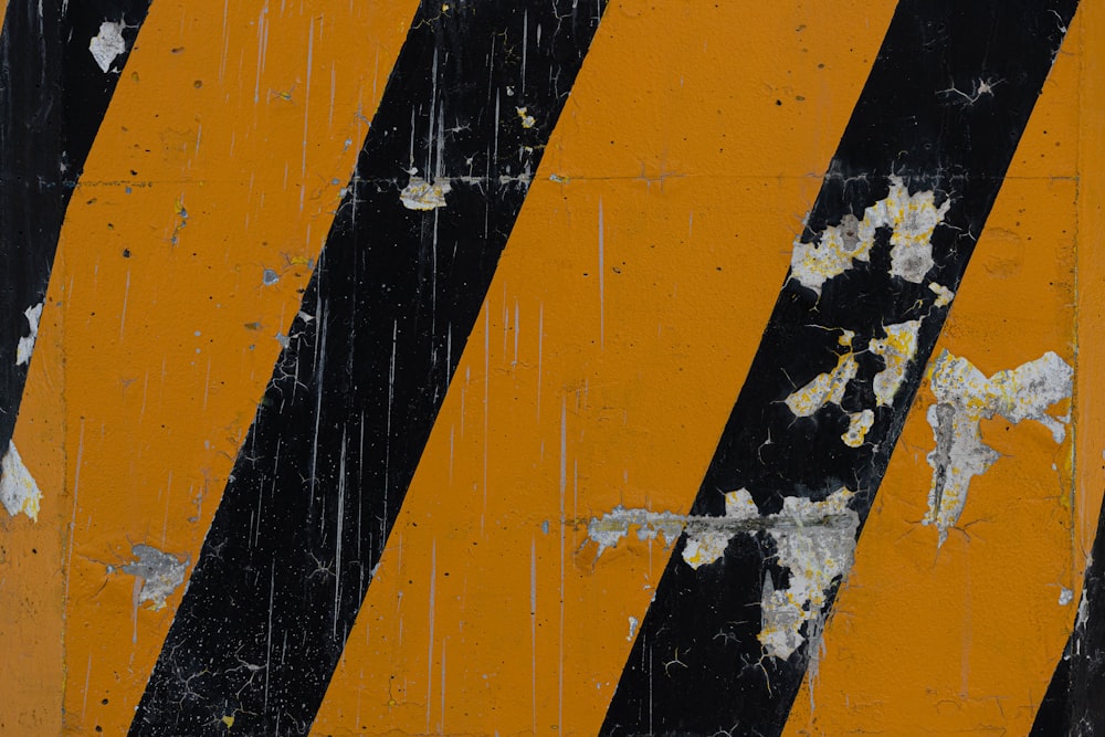 a close up of a yellow and black striped sign