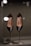 A pair of elegant black leather high-heeled shoes displayed on metal stands. The shoes appear sleek and sophisticated, with a glossy finish. Reflective lights above enhance their shine and highlight the brand name inside the shoes.