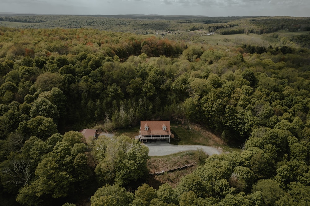 an aerial view of a house in the middle of a forest