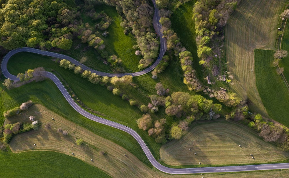 an aerial view of a winding road in the countryside