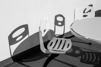 two chairs and a table with a shadow on the wall
