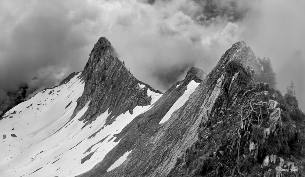 a black and white photo of a snow covered mountain