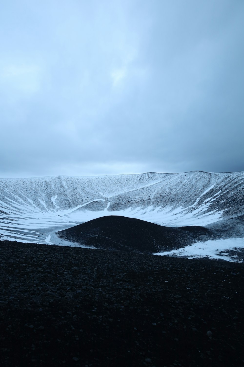 a snowy landscape with a mountain in the background